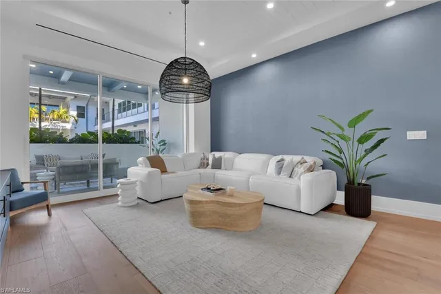 a living room with furniture a chandelier and a chandelier