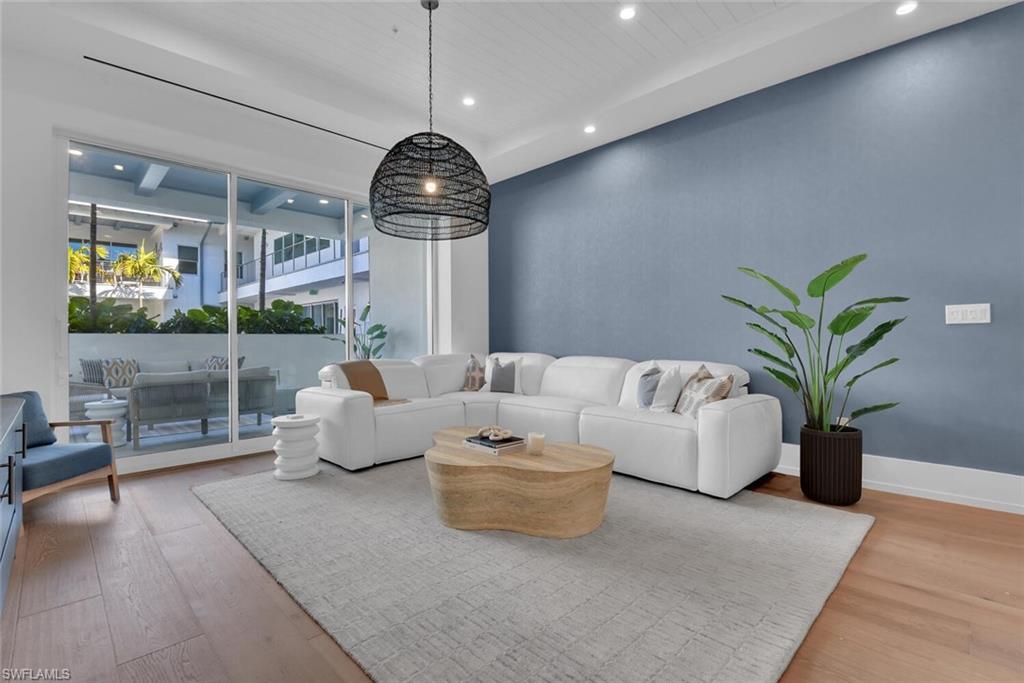201 8th Street South, Unit 209 Naples, FL 34102 - Photo 6 of 41 a living room with furniture a chandelier and a chandelier