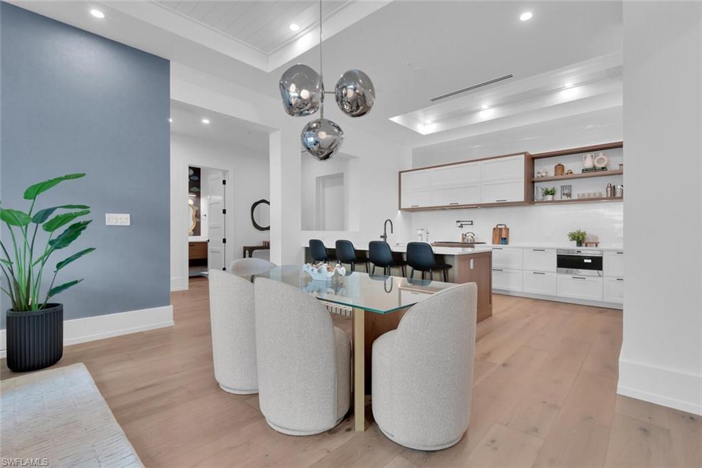 201 8th Street South, Unit 209 Naples, FL 34102 - Photo 8 of 41 a living room with furniture and a chandelier