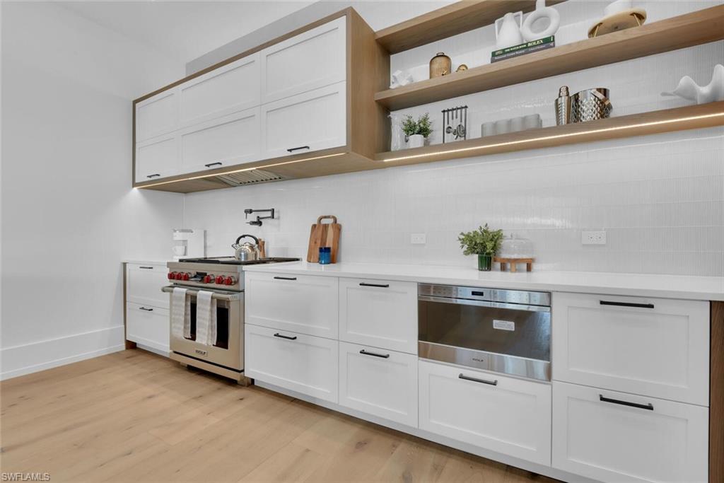 201 8th Street South, Unit 209 Naples, FL 34102 - Photo 10 of 41 a kitchen with cabinets and white stainless steel appliances