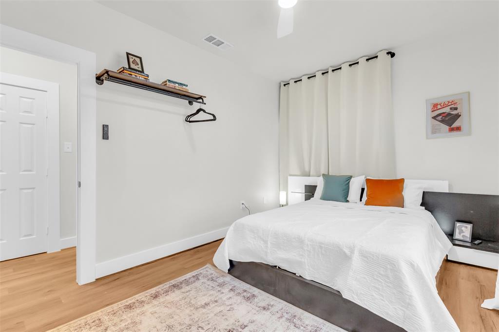 4121 Junius Street, Unit 4123 Dallas, TX 75246 - Photo 20 of 23 a bedroom with a bed and a dresser