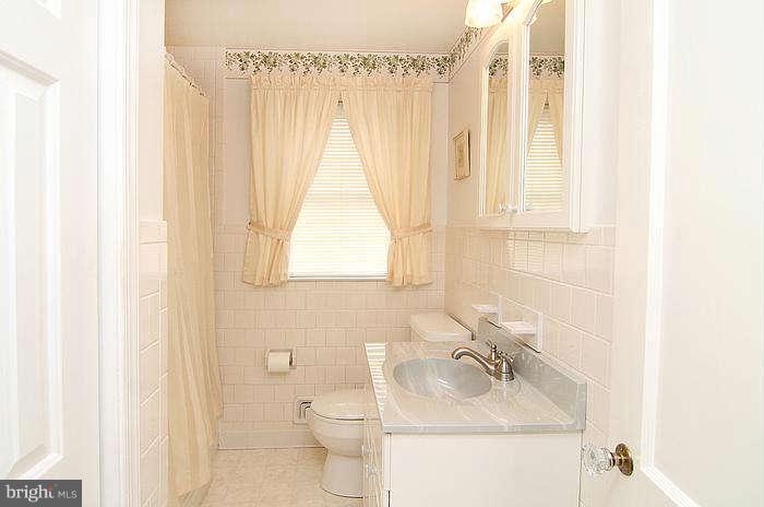 1227 Newfield Road Baltimore, MD 21207 - Photo 11 of 16 a bathroom with a sink and a toilet