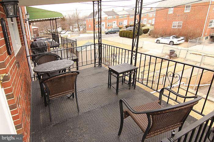 1227 Newfield Road Baltimore, MD 21207 - Photo 14 of 16 a view of a chairs and table in the balcony