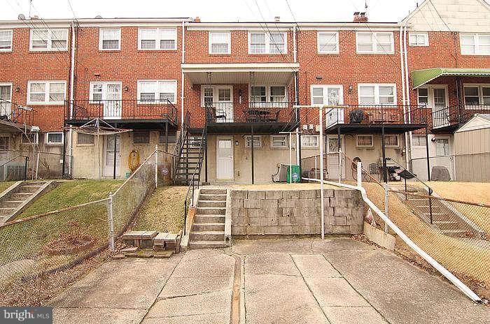 1227 Newfield Road Baltimore, MD 21207 - Photo 16 of 16 a view of a brick building with a outdoor seating