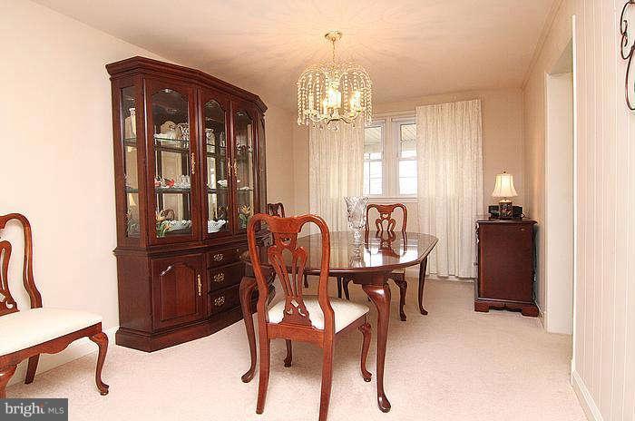 1227 Newfield Road Baltimore, MD 21207 - Photo 5 of 16 a view of a dining room with furniture and chandelier