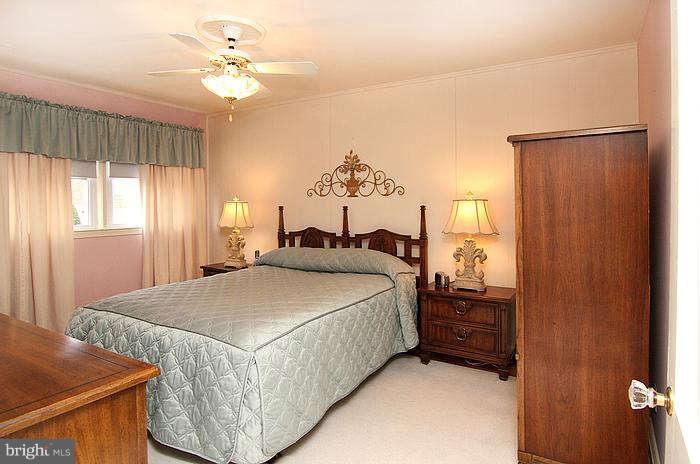 1227 Newfield Road Baltimore, MD 21207 - Photo 8 of 16 a bed room with a bed and a chandelier