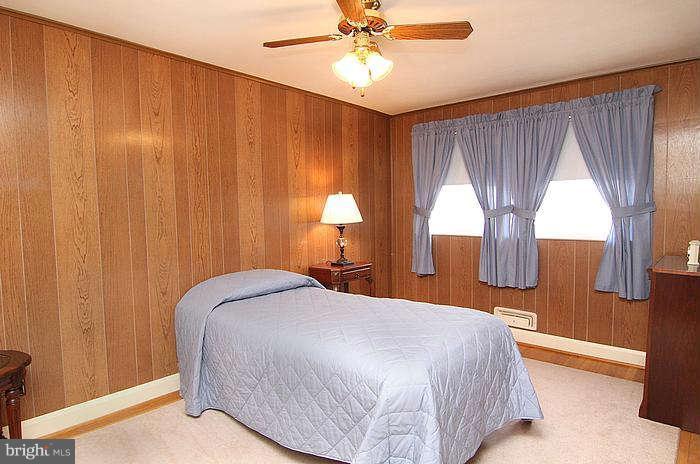 1227 Newfield Road Baltimore, MD 21207 - Photo 10 of 16 a bedroom with a bed and a window