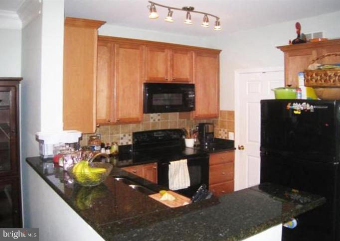 1601 Spring Gate Dr., Unit 1214 McLean, VA 22102 - Photo 5 of 16 Updated kitchen with granite + extra tall cabinets