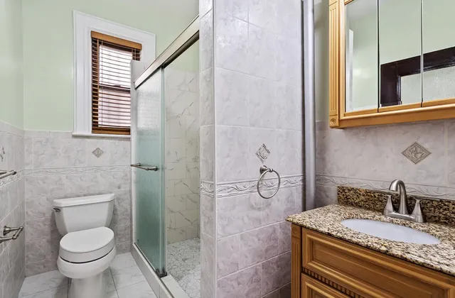 a view of a hallway with a glass door and a window