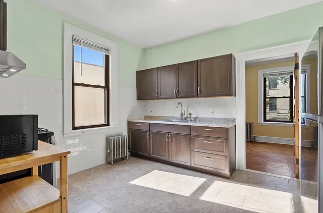 a bathroom with a granite countertop sink a toilet and a mirror