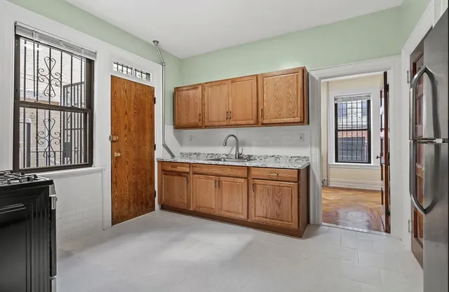 a kitchen with granite countertop a sink cabinets and window