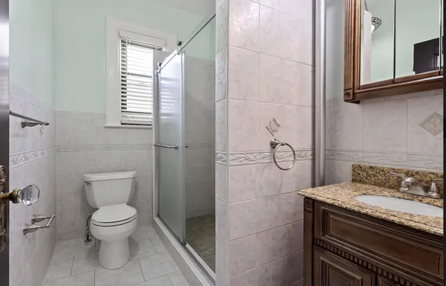 a kitchen with granite countertop a refrigerator and a sink