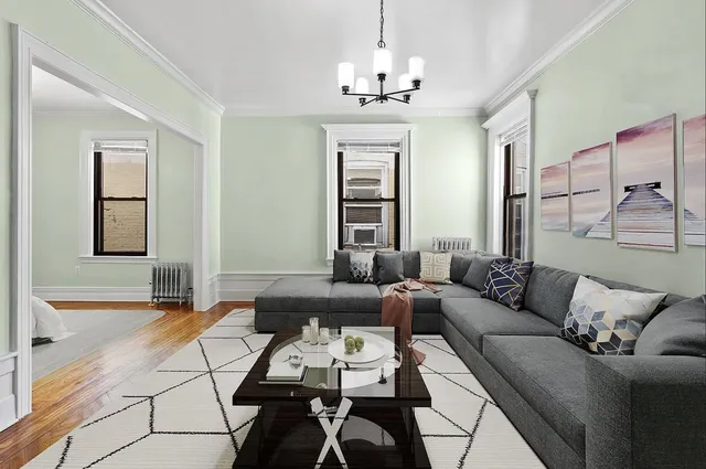 a living room with furniture a chandelier and a window