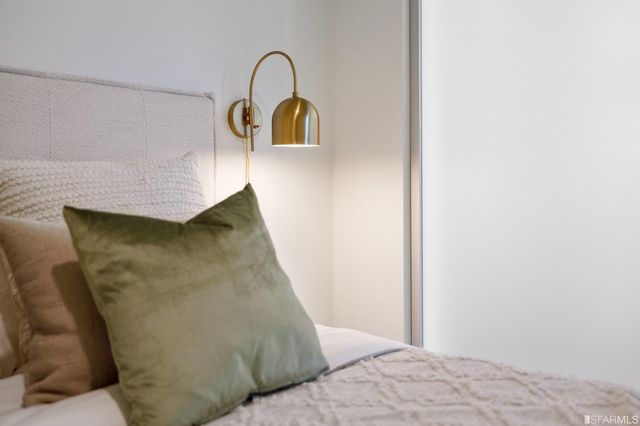 a bedroom with a bed and a chandelier