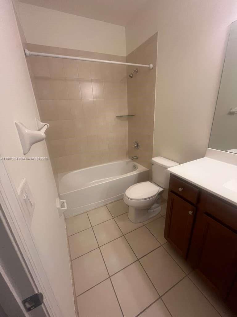11481 Southwest 250th Street, Unit 11481 Homestead, FL 33032 - Photo 11 of 12 a bathroom with a bathtub and toilet
