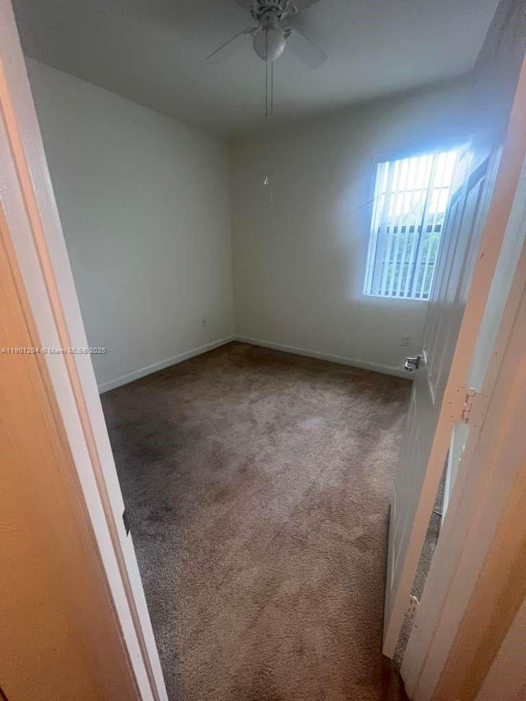 11481 Southwest 250th Street, Unit 11481 Homestead, FL 33032 - Photo 12 of 12 a view of an empty room with a window
