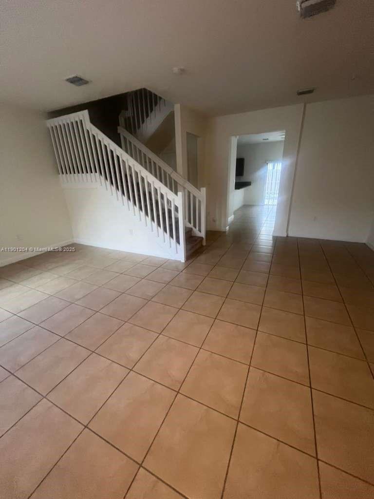 11481 Southwest 250th Street, Unit 11481 Homestead, FL 33032 - Photo 2 of 12 a view of an entryway with a rug
