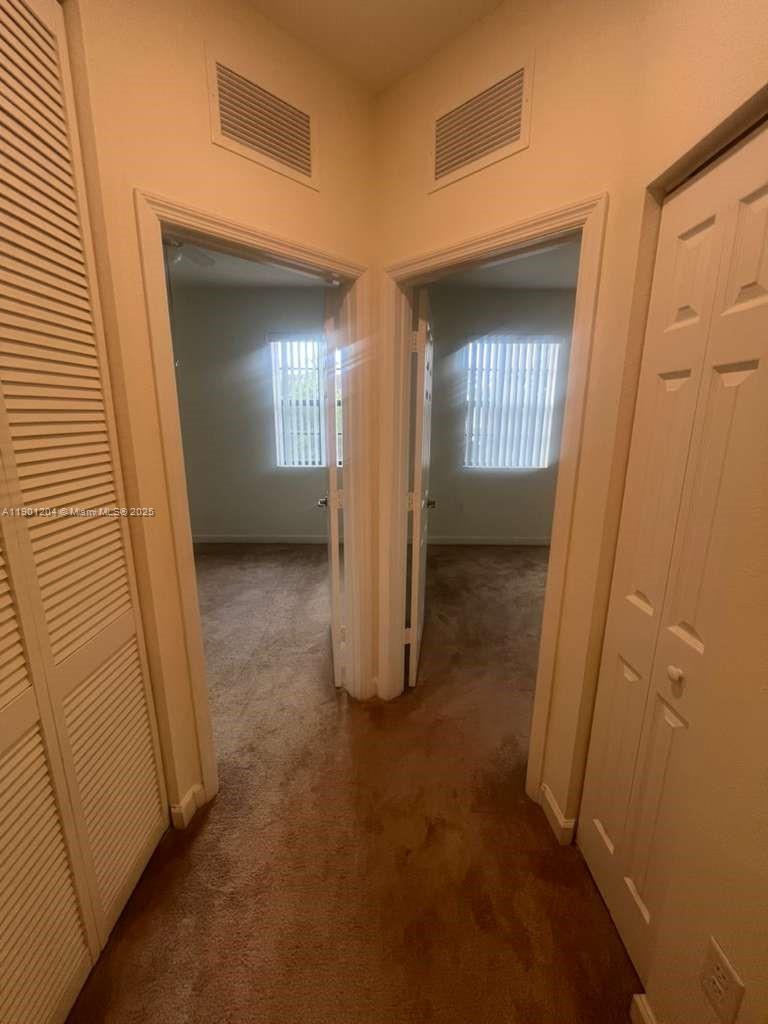 11481 Southwest 250th Street, Unit 11481 Homestead, FL 33032 - Photo 10 of 12 an empty room with windows