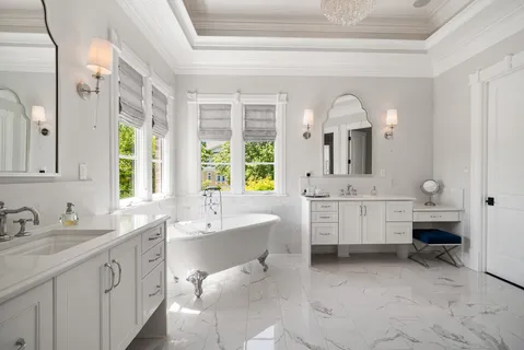a large kitchen with stainless steel appliances a stove a sink dishwasher and a flat tv screen next to a window