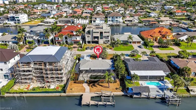 an aerial view of a houses with swimming pool