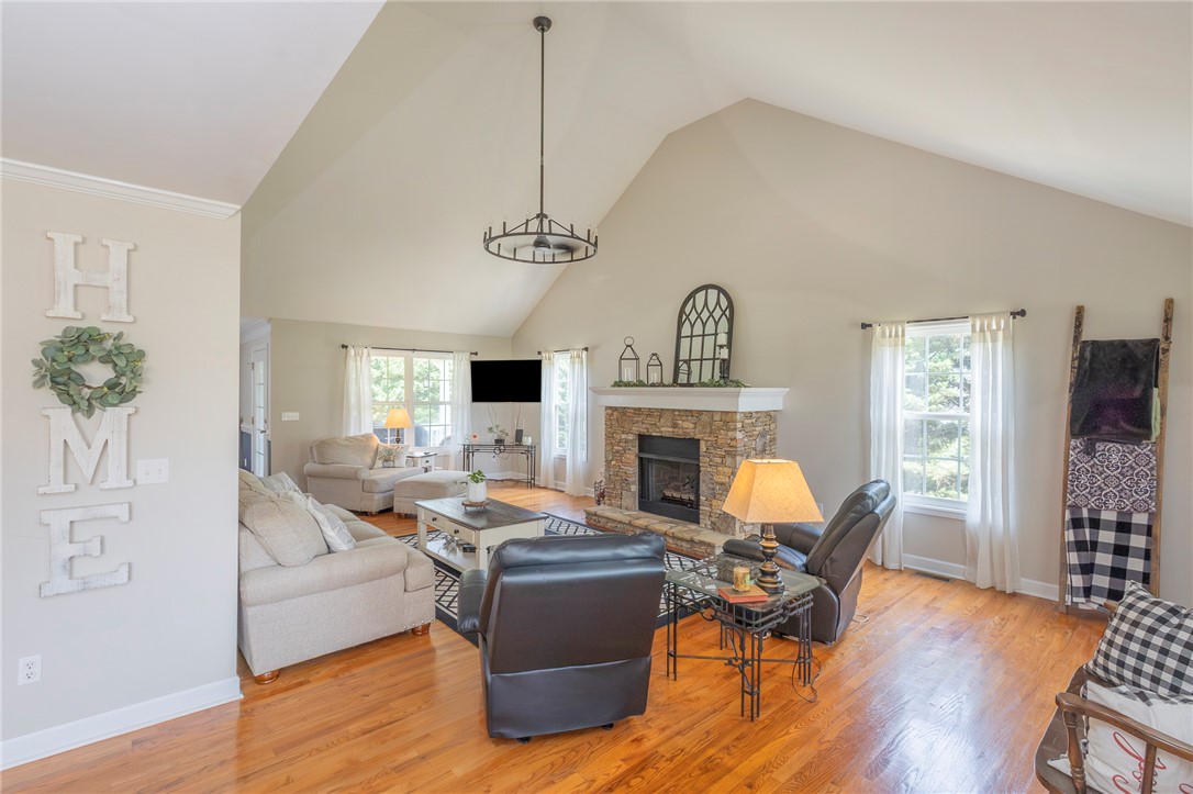 861 North Old Pendleton Road Liberty, SC 29657 - Photo 5 of 45 A stone-clad fireplace and soaring vaulted ceilings define this inviting living area.