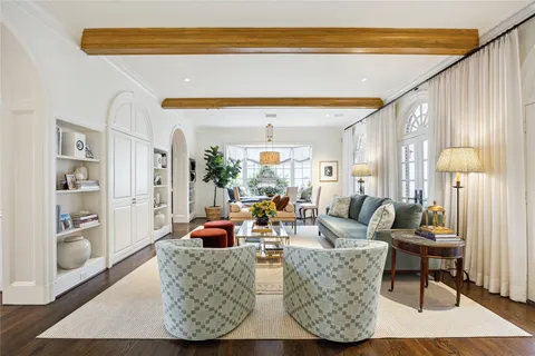 a living room with furniture a window and a rug