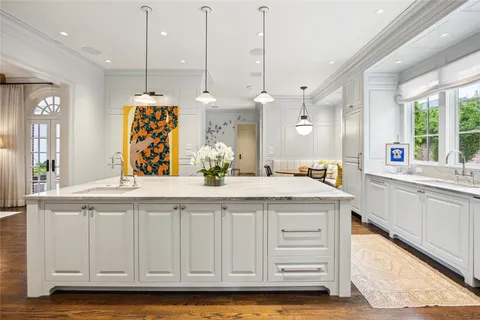 a kitchen with stainless steel appliances kitchen island granite countertop a sink a counter space and a window