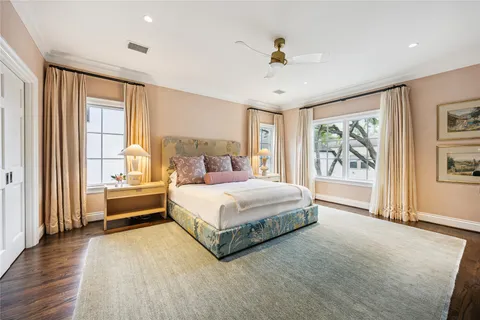 a spacious bedroom with a large bed and a large window