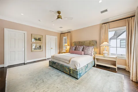 a spacious bedroom with a large bed and a chandelier