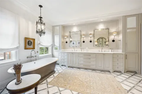 a room with a chandelier furniture and kitchen view