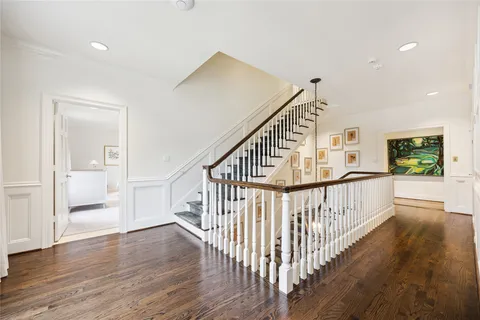 a view of staircase with wooden floor and windows