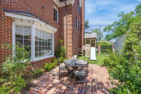 a view of a building with a backyard and sitting area