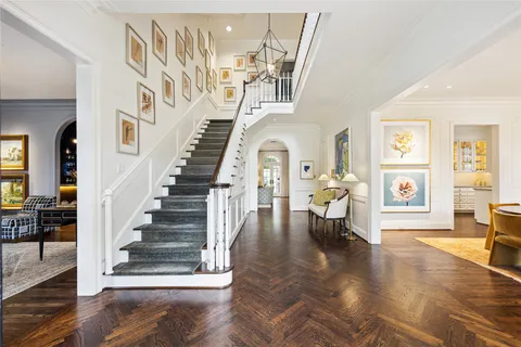a view of entryway and hall with wooden floor