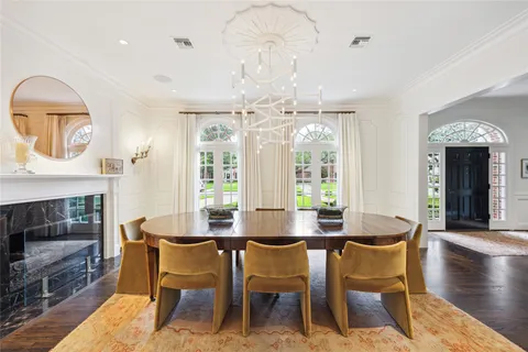 a dining room with furniture window fireplace and wooden floor