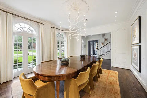 a dining room with furniture and wooden floor