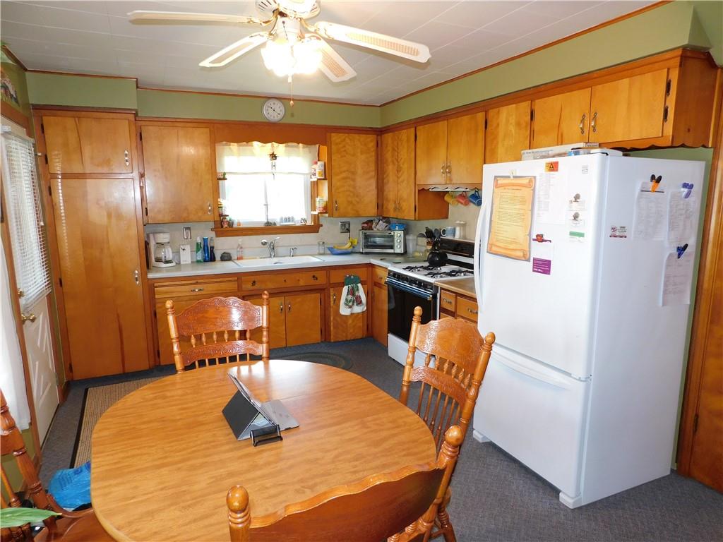 3941 Hollow Road New Castle, PA 16101 - Photo 3 of 12 a kitchen with stainless steel appliances granite countertop a refrigerator a sink a stove and island