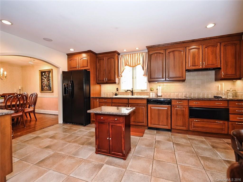 3123 Cloverfield Road Charlotte, NC 28211 - Photo 5 of 24 a kitchen with stainless steel appliances granite countertop a stove a sink dishwasher and a refrigerator with wooden cabinets