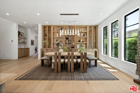 a dining room with furniture window and wooden floor