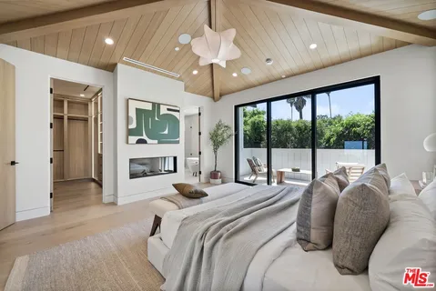 a bedroom with a large bed and a large window