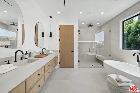 a bathroom with a double vanity sink mirror and toilet