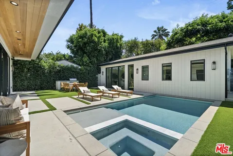 a view of a patio with couches table and chairs and potted plants
