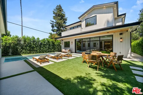 a view of a house with swimming pool and sitting area