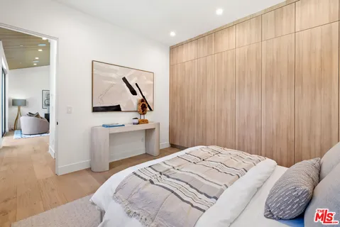 a bedroom with a bed and a view of kitchen