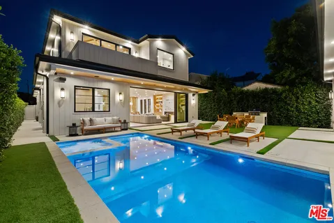 a view of a house with pool and chairs