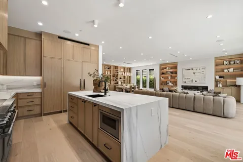 a kitchen with a stove sink and a refrigerator