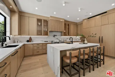 a kitchen with a sink cabinets and window