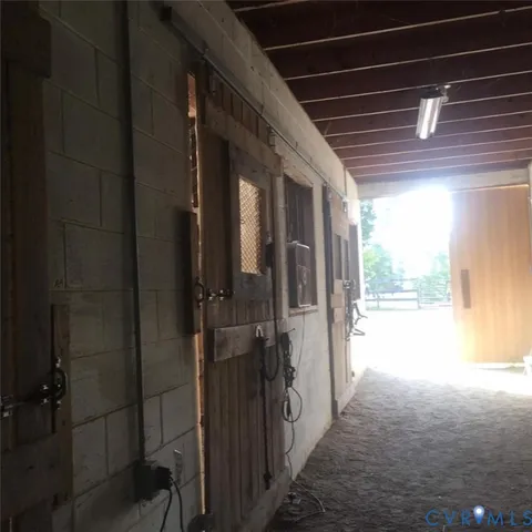 a view of hallway with stairs and furniture