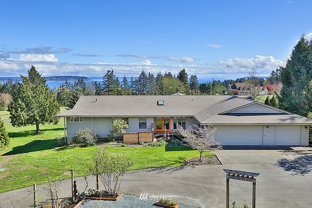 1835 Lancaster Road Freeland, WA 98249 - Photo 1 of 25 a view of a house with a yard and sitting area