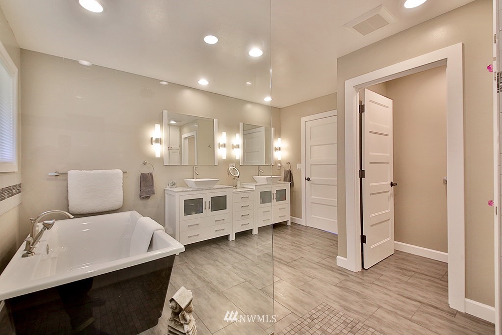 1835 Lancaster Road Freeland, WA 98249 - Photo 16 of 25 a large bedroom with a bed and a view of en suite bathroom