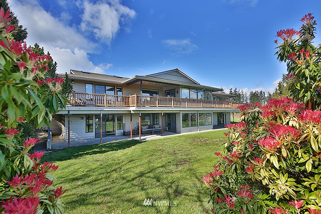 1835 Lancaster Road Freeland, WA 98249 - Photo 25 of 25 a front view of a house with a big yard and potted plants
